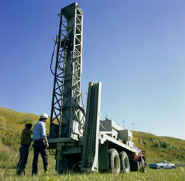 Geologists preparing a hole for the explosive charges used in seismic exploration for oil and natural gas